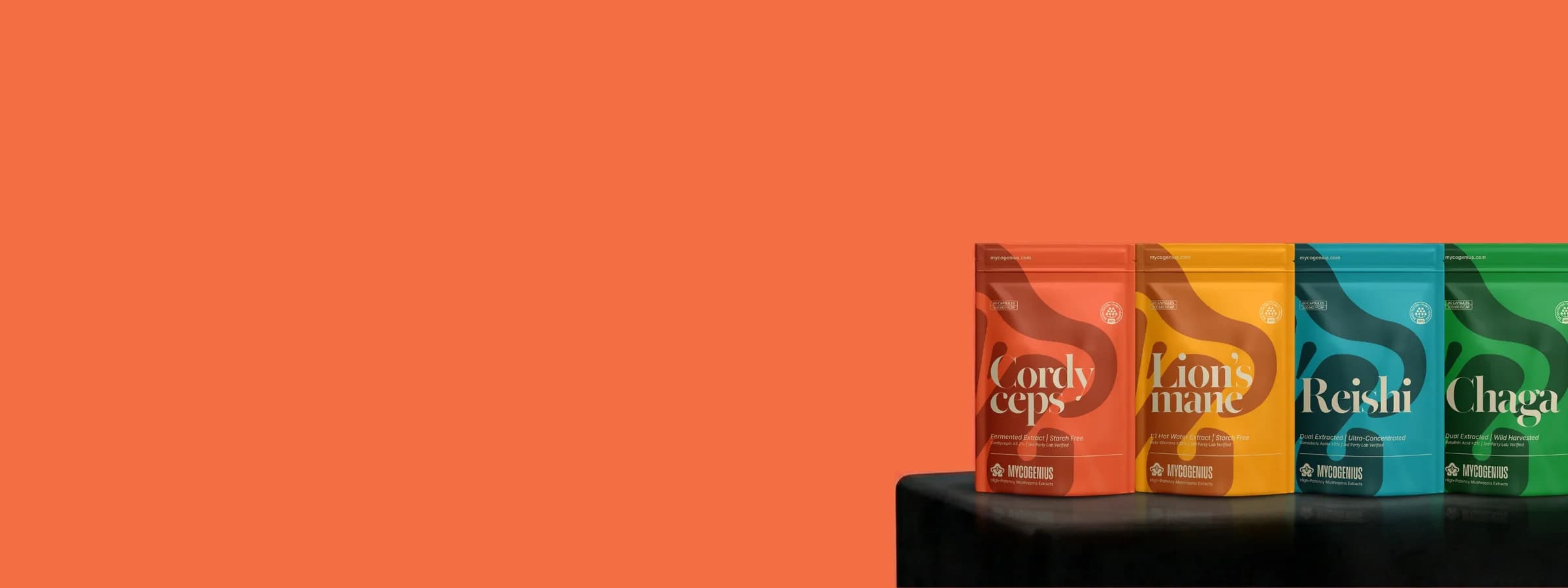 Four colorful packaging on a black surface with an orange background